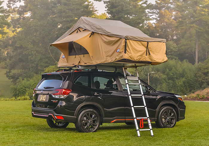 A tent mounted to the roof of a Toyota Forester