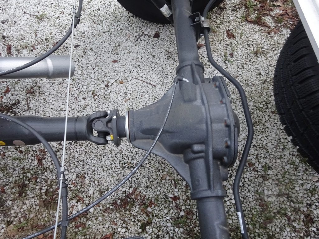Aerial view of a rear differential showing the main drive shaft running into the differential and both axles coming out of the differential to power the wheels. 